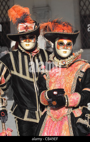 I partecipanti non identificato usura tradizionale maschera e costume durante il famoso carnevale veneziano. Foto Stock