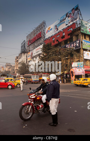 India Bengala Occidentale, Kolkata, poliziotti del traffico sotto i pannelli pubblicitari a Bentinck Street Junction Foto Stock