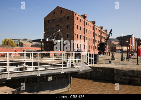 Bloccare i cancelli e vecchio edificio adibito a magazzino tramite dock bacino. Gloucester Docks Gloucestershire England Regno Unito. Foto Stock