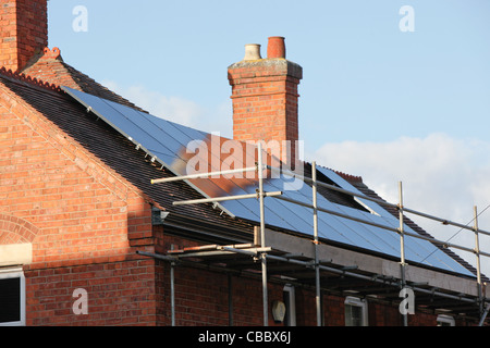 Appena installato il pannello solare array,per generare energia rinnovabile da sun. L'installazione è su un tetto a spioventi su una vecchia casa Foto Stock