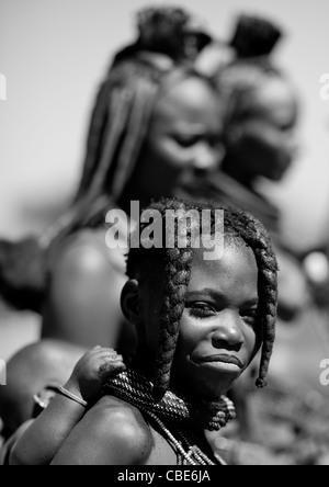 Ragazza Muhimba portando un bambino sulla schiena, villaggio di Elola, Angola Foto Stock