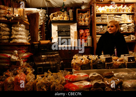 Una ragazza sta vendendo il tradizionale pane di Natale, chiamato Stollen in uno stallo al mercatino di Natale di Lipsia, in Germania. Foto Stock