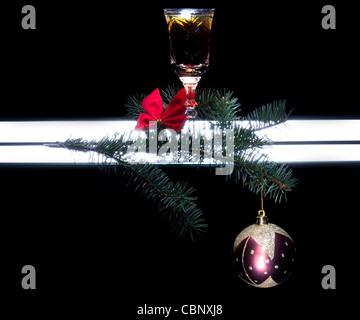 photo of still life with goblet of alcohol, tree branch and toy isolated on dark background Foto Stock