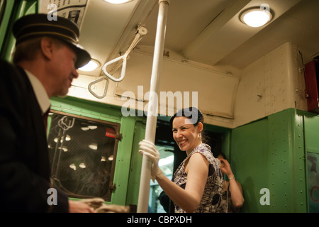 I Newyorkesi, i turisti e gli appassionati della metropolitana, alcuni nel periodo abito, a un MTA vintage Nostalgia treno stagione di Natale ride Foto Stock