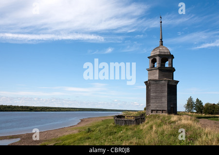 Paesaggio estivo con il vecchio campanile in legno sulla riva del fiume Foto Stock