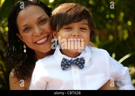 Sorridente madre figlio di contenimento sul suo giro Foto Stock