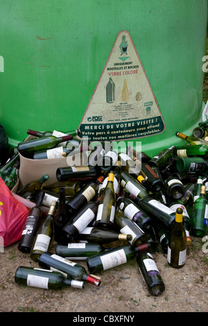 Il vetro del punto di raccolta / Bottle Bank con oggetto di dumping le bottiglie di vino nella parte anteriore Foto Stock