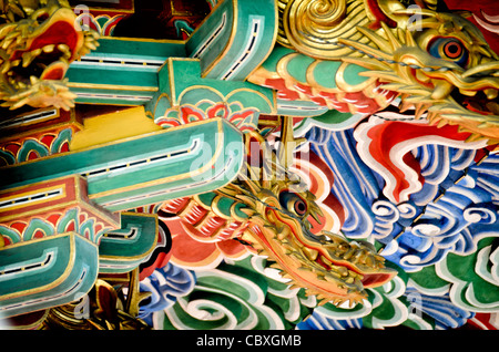 Tempio Naritasan Shinshoji a tre piani, Pagoda Rafters Narita Giappone // NARITA, Giappone - travi ornamentali della Pagoda a tre piani al tempio Naritasan Shinshoji mostrano colori vibranti e intricati disegni caratteristici della tradizionale architettura buddista giapponese. La pagoda alta 25 metri è stata originariamente costruita nel 1712 e rappresenta una delle strutture più significative del tempio. Il tempio Naritasan Shinshoji, fondato nel 940, è dedicato a Fudo Myoo e funge da tempio principale del ramo Chisan della setta buddista Shingon. Il complesso del tempio attrae milioni di visitatori ann Foto Stock