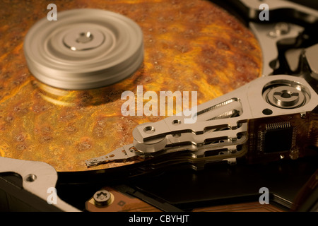 Simbolico di salvataggio dati tema che mostra un aperto hard disk con il simbolo superficie corrosa Foto Stock