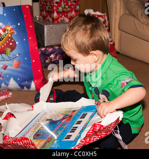 2 anno di età giovane ragazzo bambino Neonato Bimbo Apertura di un Natale regalo di Natale presenta Foto Stock