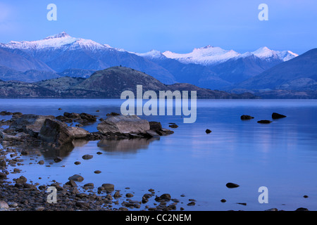 Mattina twilight oltre il lago Wanaka e le vette innevate delle Alpi meridionali, Wanaka, Otago, Nuova Zelanda Foto Stock
