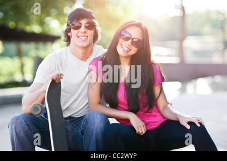 Stati Uniti d'America, Washington, Seattle, giovani multi-razziale matura in posa con lo skateboard Foto Stock