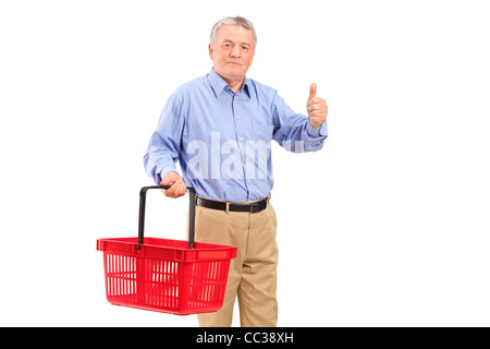 Un uomo maturo tenendo un vuoto carrello e dando pollice in alto Foto Stock