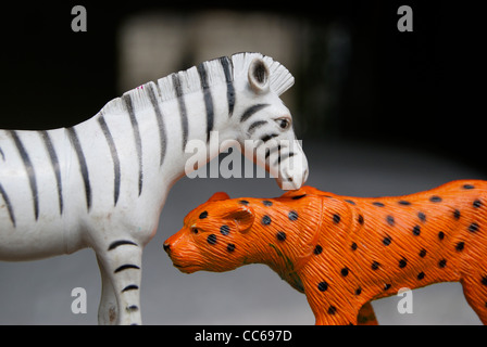 Zebra baciare una red tiger. Un piccolo giocattolo gioco. Foto Stock