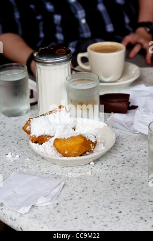 Piastra di beignets ricoperti di zucchero in polvere sul tavolo al Cafe Du Monde nel Quartiere Francese di New Orleans, LA Foto Stock