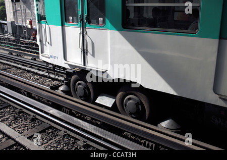 Close up di un treno della metropolitana sulla linea 6 in corrispondenza di Sevres Lecourbe stazione, Parigi. Nota i pneumatici in gomma su ruote e orizzontale delle ruote di guida Foto Stock