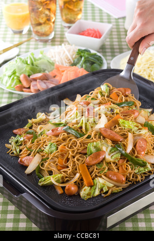 Noodles fritti sulla piastra calda Foto Stock