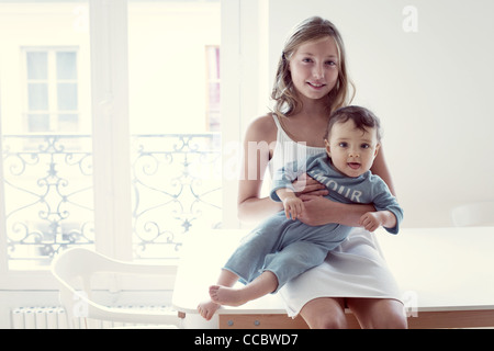 Ragazza con baby sorella sul giro, ritratto Foto Stock