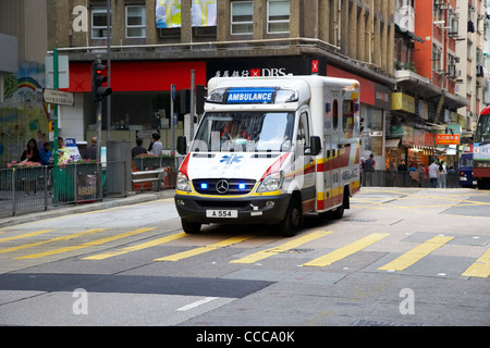 Hong kong ambulanza accelerando verso il centro della strada nel centro cittadino di RAS di Hong kong cina asia Foto Stock