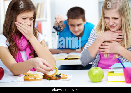 Due ragazze disgustata guardando il ragno in uno dei loro panini Foto Stock