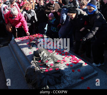 Nov 11, 2010 - Ottawa, Ontario, Canada - Persone papaveri laici verso il basso la tomba del Soldato sconosciuto durante la cerimonia nazionale di ricordo presso il National War Memorial a Ottawa. (Credito Immagine: © Kamal Sellehuddin/ZUMApress.com) Foto Stock