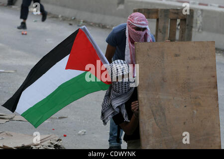 Mascherato giovani palestinesi scontro con le forze israeliane al checkpoint Qalandia tra Gerusalemme e Ramallah il 23 settembre 2011. Alcuni 22.000 polizia israeliana e della polizia di frontiera sono stati su allarme elevato attraverso il paese, pronti a rispondere ad eventuali disordini risultanti da un Palestinese bid per cercare i membri delle Nazioni Unite Foto Stock