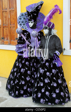 Indossare maschera frequentatori di carnevale sfilano per le strade di Venezia Foto Stock