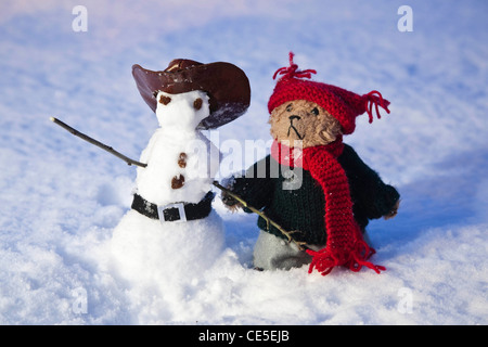 Beni, un orso di peluche nella neve con un pupazzo di neve Foto Stock