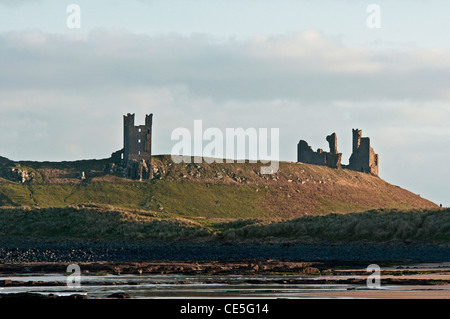 Il castello di Dunstanburgh fotografata da Embleton Bay sulla costa di Northumberland Foto Stock