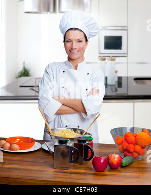 Lo chef donna ritratto con bianco uniforme in cucina Foto Stock