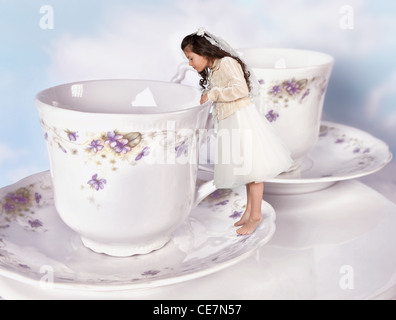 Ragazza in miniatura in Alice nel paese delle meraviglie dress ristretto  per le dimensioni di una tazzina Foto stock - Alamy