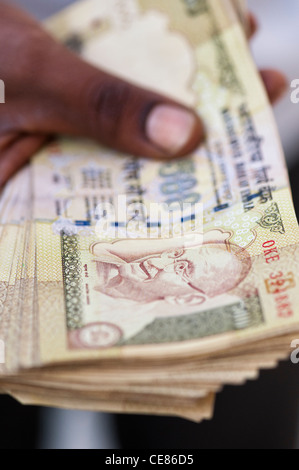 Indian man mano che tiene un mazzetto di 500 rupee note che sono state demonetised nel novembre 2016. India Foto Stock