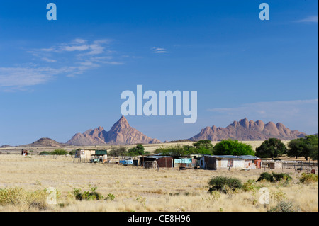 Piccola dimora con i picchi di Spitzkoppe sullo sfondo. Damaraland, Namibia.. Foto Stock