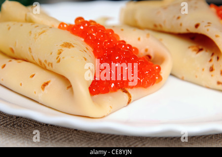 Frittelle con caviale rosso sulla piastra Foto Stock