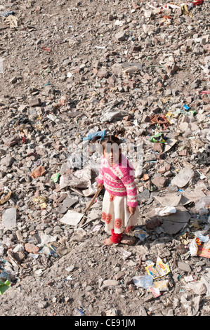 Bambina gioca in alveo secco che è piena di spazzatura, Rishikesh, Uttarakhand, India Foto Stock