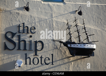 La nave hotel, Brancaster. Un modello di nave è appeso alla parete esterna. Foto Stock