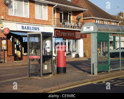 Sfilata di negozi locali con casella telefono, casella postale e il bus shelter in batteria Olivers un sobborgo di Winchester, Hampshire. Inghilterra Foto Stock