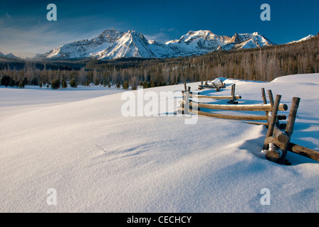 Questo registro recinto conduce nelle montagne coperte di neve di Idaho Foto Stock