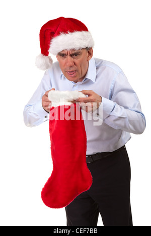 Business man in Santa Hat gettando in calza di Natale Foto Stock