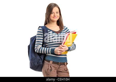 Scuola sorridente ragazza in posa con i suoi libri isolati su sfondo bianco Foto Stock