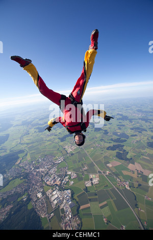 Paracadutista ragazza è pratica la testa in posizione abbassata e il volo libero su un bel paesaggio con oltre 150 km/h. Foto Stock