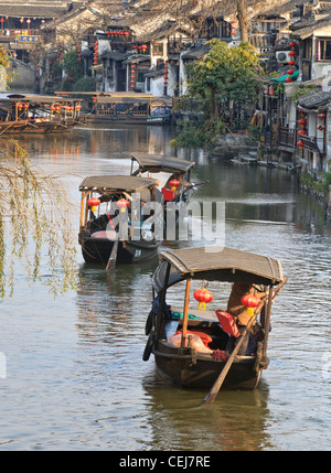 Le imbarcazioni che trasportano i turisti sulle vie navigabili nella bellissima città di Xitang, Zhejiang, Cina Foto Stock