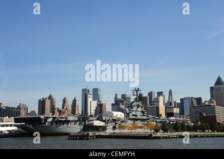 Cielo Blu vista dal fiume Hudson da Manhattan skyline, Pier 86 autunno alberi, USS Intrepid Portaerei Museum di New York Foto Stock