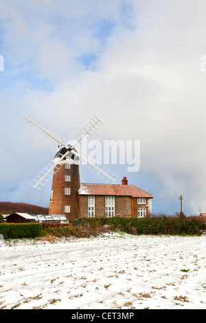 La neve che ricopre il suolo da Weybourne Mulino a vento, un grado ll elencati edificio costruito nel 1850. Foto Stock