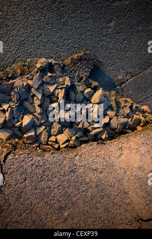 Asfalto, rocce, pavimentazione, immagini grafiche, luce drammatica. In rappresentanza di costruzione, grigio, nero, marrone Colori smorzati Foto Stock