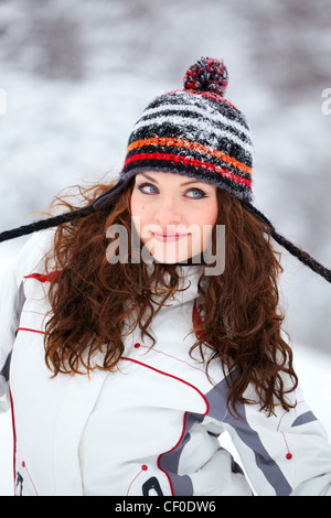 Bella giovane donna ritratto, vestito casualmente all'aperto in inverno a giocare nella neve. Foto Stock