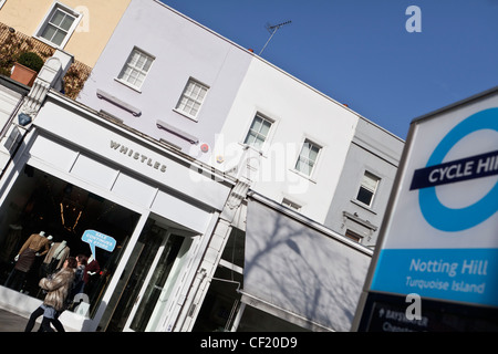 Negozio di vestiti e un ciclo di segno di noleggio in Westbourne Grove. Foto Stock