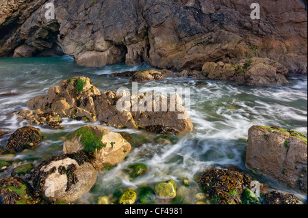 Mare moto vorticoso in ed intorno a rocce nel foro di scale, una relativamente nuova cove che è la formazione di appena a ovest di Lulworth Cove nel Dorse Foto Stock