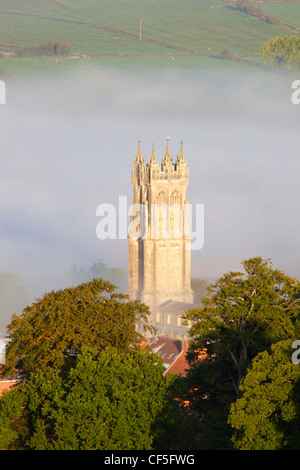 Il campanile di San Giovanni Battista chiesa circondato da nebbia, visto dalla parte superiore di Glastonbury Tor. Foto Stock