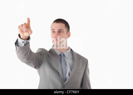 Imprenditore toccando qualcosa Foto Stock